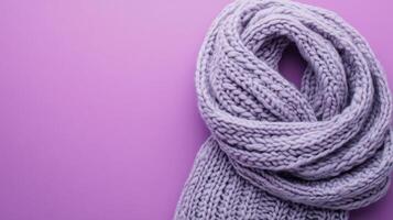 Warm purple knitted scarf on a pastel background showcasing texture and color ideal for winter fashion photo