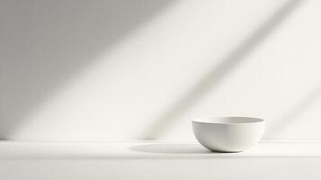 Minimalist white bowl on a light surface with soft shadows in a bright interior space during the day photo