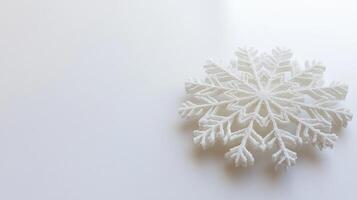Unique white snowflake design displayed on a simple background highlighting winter elegance and seasonal charm photo