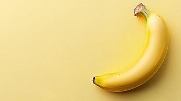 Bright yellow banana resting on a vibrant yellow background highlighting its natural curves and texture photo