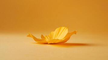 Bright yellow flower petal resting on a soft yellow background in a serene and harmonious setting photo