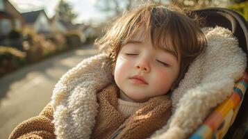 Close-up of a small sleeping baby in a stroller photo