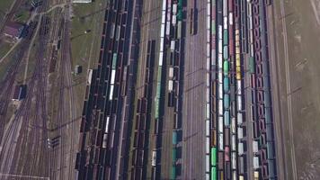Aerial view of Railway sorting station and A lot of wagons at a railway. Drone flies over railway tracks. 4k quality video