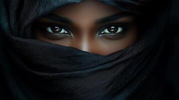 Intriguing eyes peer from beneath a dark scarf, beautifully reflecting the surrounding light photo