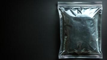 A shiny black package sits alone on a dark surface, creating intrigue and sparking imagination photo