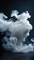 Abstract white smoke swirls against a dark background, creating an ethereal and artistic composition. photo