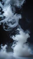 Abstract image of swirling white smoke against a dark background. Perfect for designs needing a mysterious or ethereal feel. photo