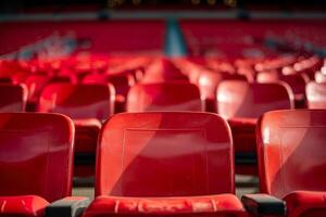 Vibrant red stadium seats are arranged in neat rows, ready for enthusiastic fans during a thrilling sports event photo
