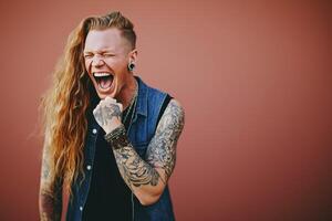 Portrait of joyful drag queen against a vibrant red background showcasing gender fluidity and self-expression photo