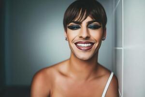 Vibrant portrait of a joyful drag queen laughing against a striking red background in a playful and dynamic setting photo