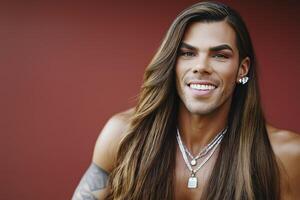 Joyful drag queen shares laughter against a vibrant red backdrop in a striking portrait photo