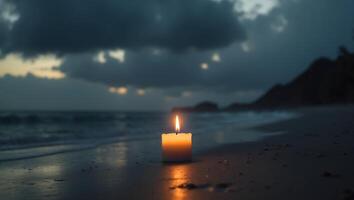 Tranquil Seaside Scene with a Flickering Candle Illuminating a Dark Beach Under a Dramatic Overcast Sky at Dusk photo