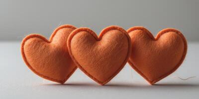 Three Orange Felt Hearts Row Close Up Valentine's DayThree Orange Felt Hearts Row Close Up Valentine's Day. photo