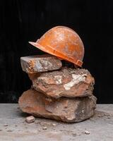 Hard hat resting on a pile of bricks photo