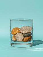 Stones in a glass on a basic background photo