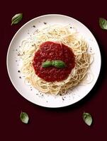 Overhead view of a plate of spaghetti with tomato sauce and basil. photo