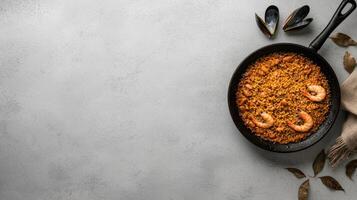 Overhead view of a delicious seafood paella in a rustic pan, garnished with shrimp and mussels photo