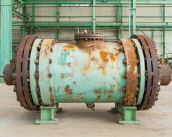 Rusty industrial pipe in a factory setting photo