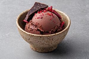 Close up of a delicious chocolate chili ice cream scoop in a rustic bowl photo