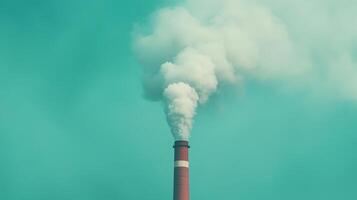 Industrial Power Plant Emitting Thick CO2 Smoke Against Turquoise Sky Highlighting Environmental Impact and Pollution Concerns with Clear Atmospheric Conditions and Dramatic Visual Contrast photo