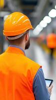 Car Factory Engineer in Work Uniform Using Tablet for Inspection in Modern Industrial Setting with Bright Lighting photo