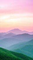 Sunrise Over Lush Green Mountain Range with Pink and Orange Sky in Vertical View photo