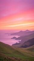 Majestic Timelapse of Vibrant Orange Sunrise Over Coastal Cliffs and Calm Ocean Seen from Elevated View in Serene Morning Atmosphere with Layers of Rolling Hills Under Colorful Sky photo