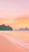 Serenity at Sunrise with Dramatic Orange and Pink Sky over Calm Ocean and Silhouette of Mountains with Gentle Waves on Sandy Beach during Sunrise in a Coastal Landscape photo