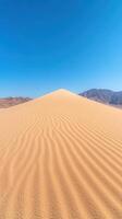 Majestic Vertical View of Expansive White Sand Dunes Under Clear Blue Sky in Serene Desert Landscape photo