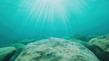 Underwater Bubbles Rising Towards Sunlit Surface with Light Rays Highlighting Rocks in Clear Aqua Water photo