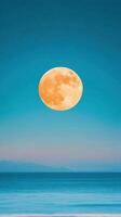 Full Moon Over Calm Sea at Night in Vertical Frame with Vibrant Colors and Clear Sky Captured in 9 16 Aspect Ratio Perfect for Backgrounds and Nature Concepts photo