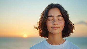Tranquil Sunset Portrait of Young Woman With Eyes Closed, Peaceful Expression, Soft Backlight, Serene Ocean View, Warm Tones, Calm Horizon, Reflective Mood, Meditative Atmosphere, Gentle Breeze photo