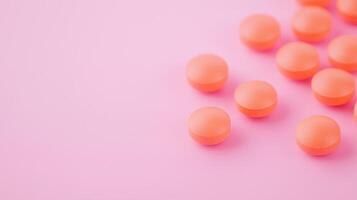 Orange Pills Scattered on Pink Surface in Flat Lay Style for Medical and Pharmaceutical Concepts photo