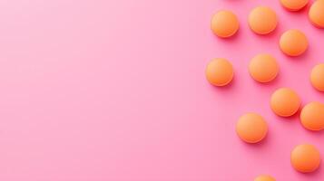 Orange Pills Scattered on Vibrant Pink Surface in Artistic Flat Lay with Copy Space and Modern Design photo