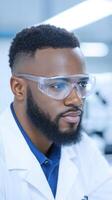 Close-up portrait of a male scientist wearing safety goggles and a lab coat in a modern laboratory. Science, research, and innovation concept for educational and professional design photo