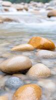 Vertical View of a Streaming River Over Smooth Stones in Natural Setting, Showcasing Serenity and Calmness, Perfect for Nature Lovers and Landscape Photography Enthusiasts photo