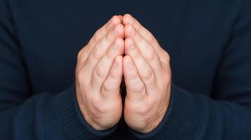 Clasped Hands in Prayer Against Dark Background Symbolizing Faith and Spirituality in Low Light Close Up Photography Focusing on Human Emotion and Devotion for Inspirational Religious Concepts photo