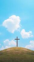 Cross on Hill Under Blue Sky with Clouds Symbolizing Redemption and Faith in Nature Landscape Photography Reflecting Spiritual Journey and Christian Belief in Peaceful Environment photo