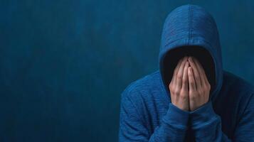 Social Media Anxiety Concept Featuring Person in Hoodie on Dark Background Highlighting Cyberbullying and Mental Health Struggles photo