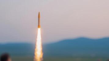 Rocket Launch Against Mountainous Horizon Capturing World Space Week Celebration in Evening Sky Featuring Blurred Foreground and Vivid Contrail Inspiring Exploration with Atmospheric Lighting photo