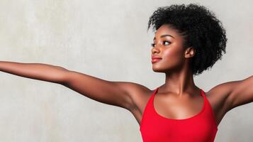 Confident Woman in Red Tank Top with Prominent Birthmark Displaying Strength and Empowerment in Studio Setting with Neutral Background photo