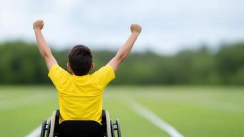Celebrating Athletic Achievement Young Athlete with Physical Disability in Wheelchair on Track, Joyfully Raising Arms Against Green Field Background, Embracing Positive Emotion and Determination photo