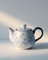 there is a tea pot with a blue and white design on it photo
