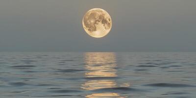 Crescent moon illuminates lake with gentle golden ripples of light and tranquility photo