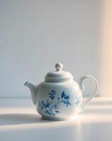 there is a tea pot with a blue and white design on itthere is a tea pot with a blue and white design on it. photo