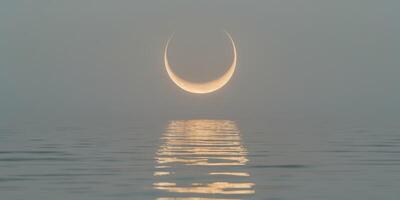 Crescent moon illuminates lake with gentle golden ripples of light and tranquilityCrescent moon illuminates lake with gentle golden ripples of light and tranquility. photo