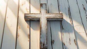 Rustic Wooden Cross on Weathered Planks with Sunlight Rays photo