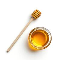 Honey jar and dipper on a white background showcasing a natural sweetener for healthy eating photo