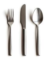 Cutlery set featuring fork, knife, and spoon with sleek stainless steel design on plain background photo