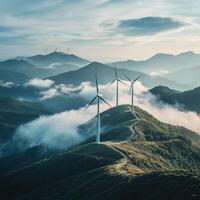 Wind turbines stand tall on a misty mountain landscape during early morning light in serene surroundings photo